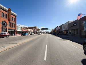 View of road with sidewalks, traffic lights, street lighting, and curbs