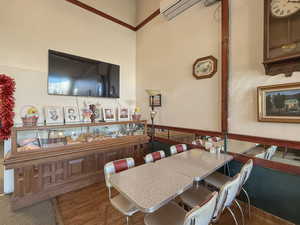 Dining room featuring a wall mounted air conditioner