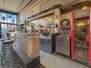 Bar featuring indoor wet bar and decorative light fixtures