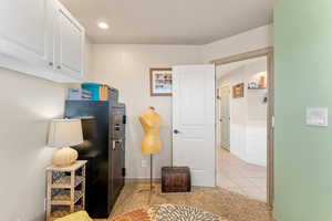 Bedroom with wainscoting, a decorative wall, and light tile patterned floors