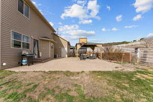 View of yard featuring fence, central AC, and a patio area
