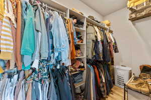 Walk in closet featuring wood finished floors