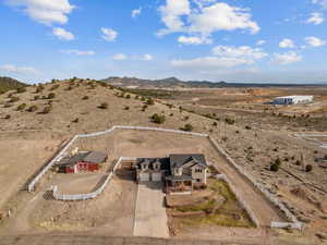 Drone / aerial view with a mountain view, view of desert, and a rural view