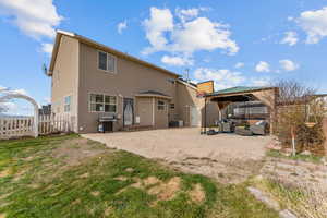 Rear view of property featuring an outdoor living space, a patio area, a gazebo, fence, and central AC