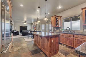 Kitchen with a center island and open floor plan, slate flooring
