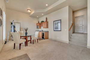 Basement dining area with beverage cooler, indoor wet bar