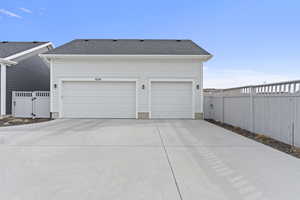 Garage featuring a gate and fence
