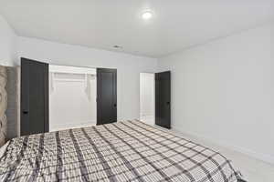 Unfurnished bedroom featuring baseboards, visible vents, a closet, and carpet floors