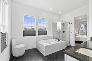 Ensuite bathroom with tile patterned floors, a shower stall, ensuite bathroom, a bath, and recessed lighting