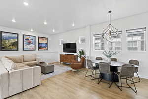 Living area with baseboards, light wood-style flooring, and recessed lighting