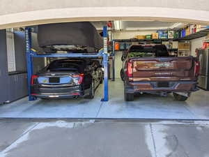 Two Car garage with car lift, extra width and depth.  Storage alongside walls and overhead.