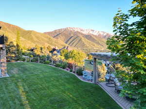 View of backyard, mountain views, and pergola.