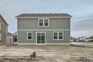 Rear view of property featuring board and batten siding