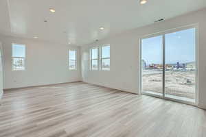 Empty room with baseboards, visible vents, recessed lighting, and light wood finished floors