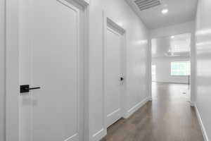 Hall with visible vents, recessed lighting, baseboards, and wood finished floors