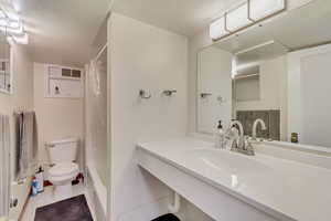 Unit 1 - Bathroom with toilet, vanity, and shower and bathtub