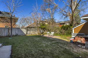 View of yard featuring a fenced backyard and a patio area