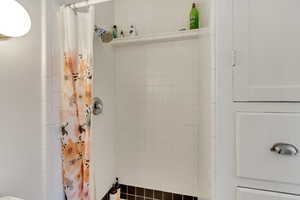 Unit 7 - Full bath featuring a tile shower