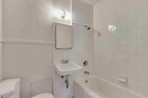 Unit 5 - Bathroom with  shower combination, toilet, and a sink