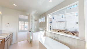 Bathroom featuring a soaking tub, a shower stall, recessed lighting, vanity, and tile patterned flooring