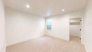 Unfurnished room featuring baseboards, light colored carpet, and recessed lighting