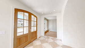 Doorway to outside with baseboards, recessed lighting, and a textured ceiling