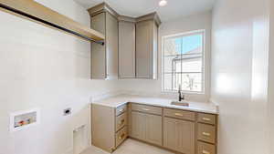 Laundry area featuring recessed lighting, hookup for a washing machine, a sink, cabinet space, and electric dryer hookup