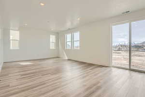 Great room featuring 9' ceilings, 8' tall sliding glass door, and LVP flooring