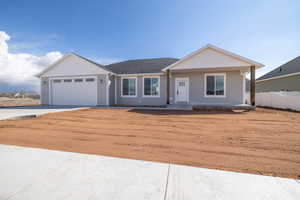 Ranch-style house with an attached garage, driveway, and fence