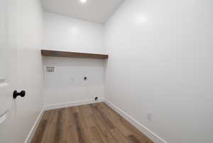 Washroom with baseboards, washer hookup, laundry area, hookup for an electric dryer, and wood finished floors