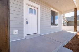 Doorway to property featuring covered porch