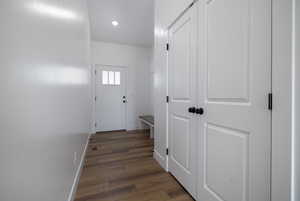 Doorway to outside with wood finished floors, baseboards, and recessed lighting