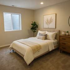 Bedroom featuring carpet floors, visible vents, and recessed lighting