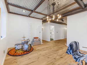 Interior space with baseboards and wood finished floors
