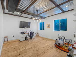 Office space with hardwood / wood-style floors and baseboards