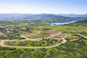 Birds eye view of property with a water and mountain view