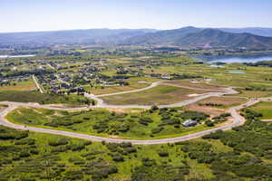 Birds eye view of property with a water and mountain view