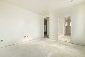Empty room with arched walkways and concrete floors