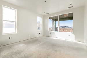 Unfurnished room featuring visible vents and concrete floors