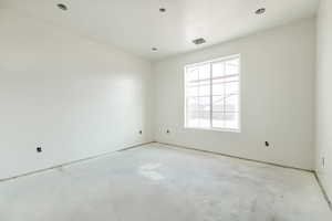 Unfurnished room featuring unfinished concrete flooring
