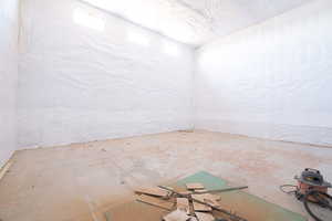 Spare room featuring concrete floors