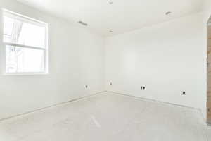 Unfurnished room with visible vents