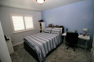 Carpeted bedroom featuring baseboards