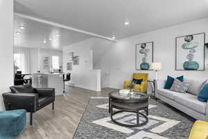 Living area featuring baseboards, recessed lighting, and light wood-type flooring