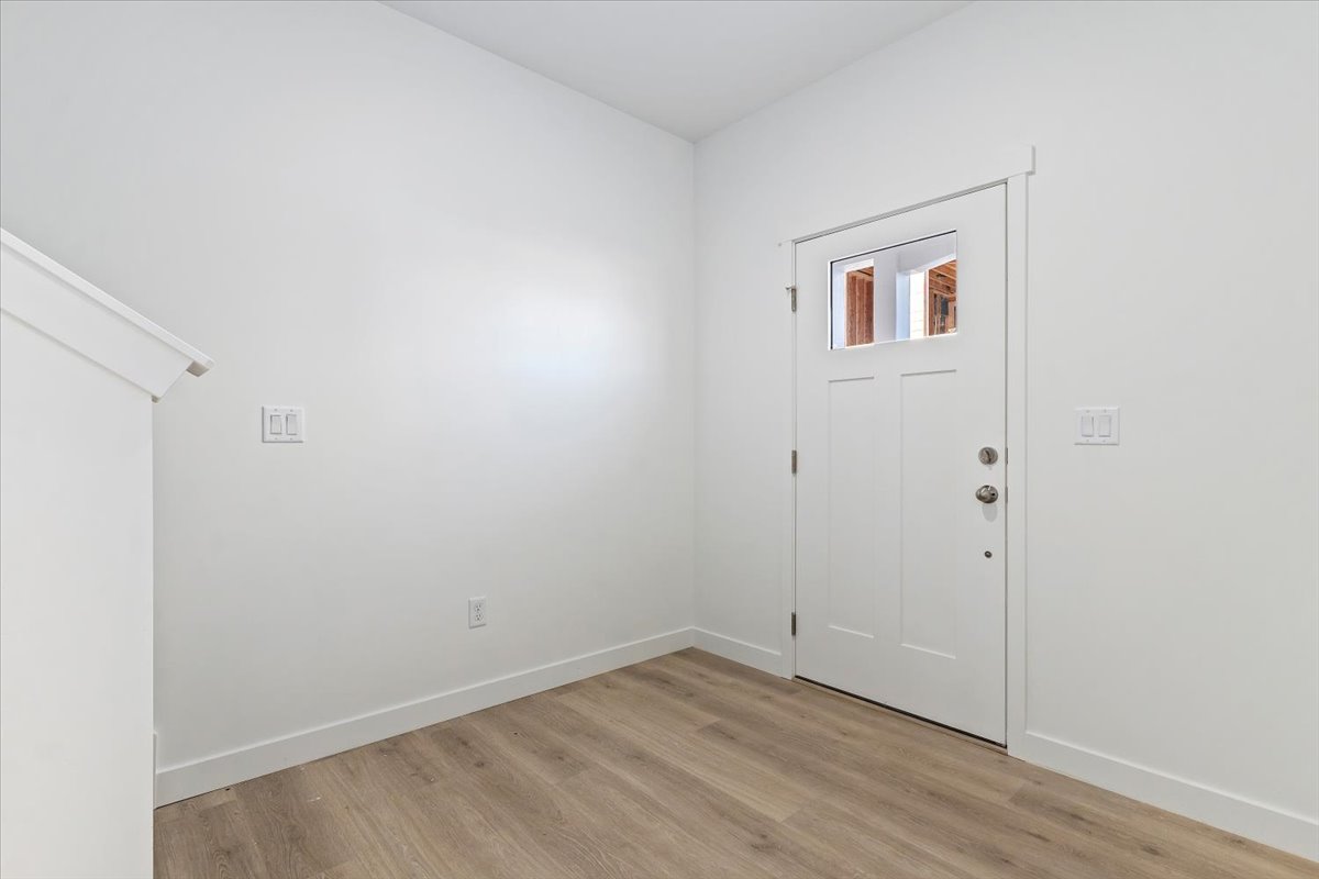 Entryway with baseboards and light wood finished floors