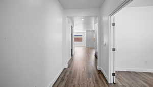 Hall featuring dark wood finished floors and baseboards