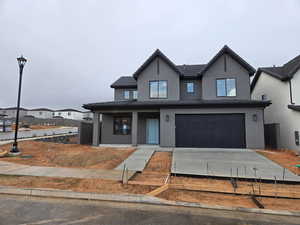 View of front of property featuring stucco siding, an attached garage, and concrete driveway