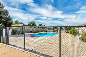 Community pool featuring fence