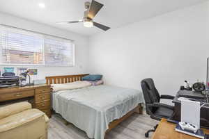 Bedroom with light wood-style floors and ceiling fan