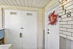 Entrance to property featuring visible vents